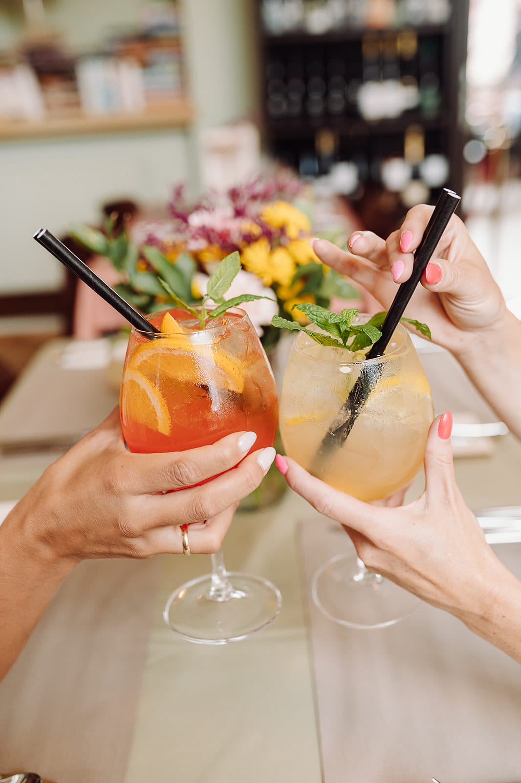 Ein Toast mit Cocktails am Bücherregal